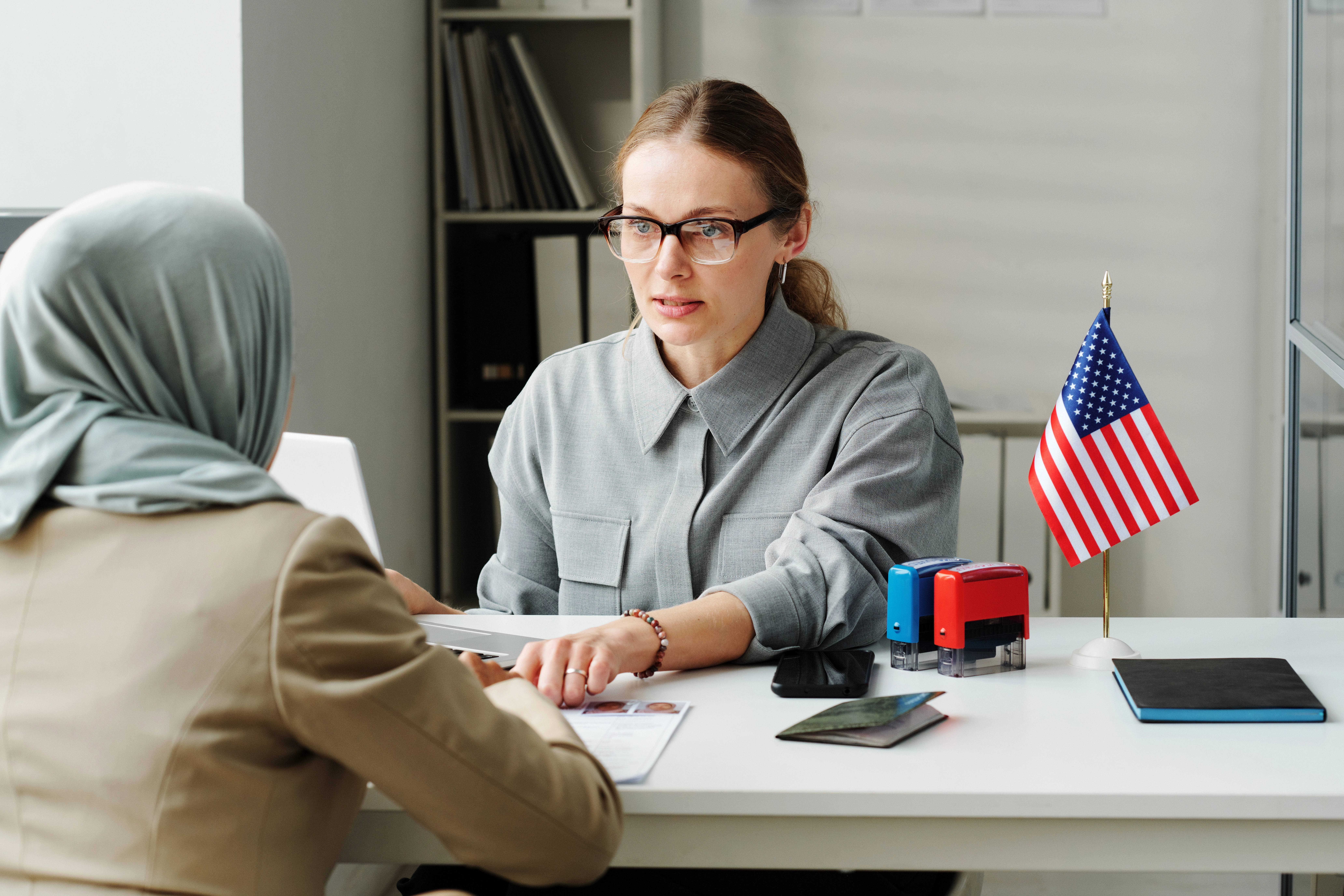 immigration lawyer sitting with immigrant in office
